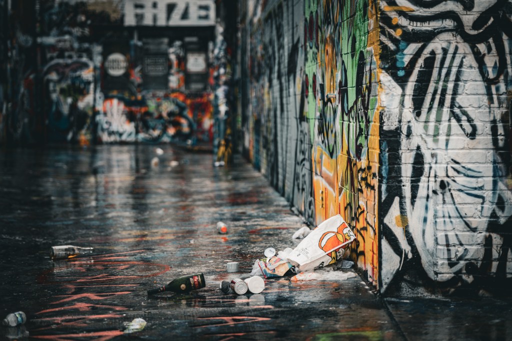 Rain-wet alley with colorful graffiti and reflections