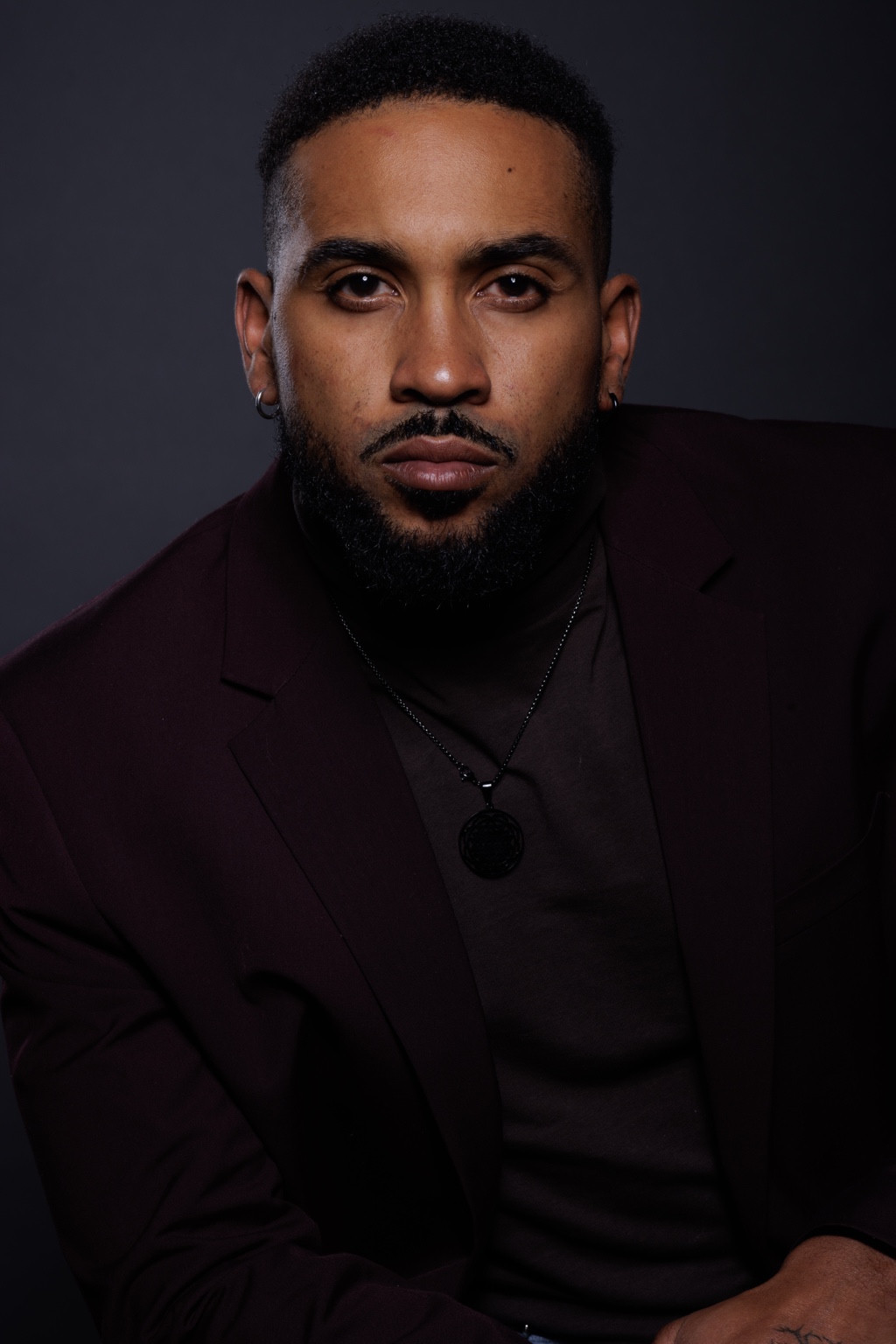 Studio portrait of a man in a dark blazer